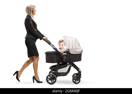 Full length shot of a young businesswoman pushing a pushchair with a child isolated on white background Stock Photo