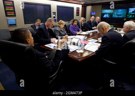 President Barack Obama meets with his national security team on Afghanistan and Pakistan in the Situation Room, Feb. 17, 2010.  General Stanley McChrystal , U.S. Commander in Afghanistan, was among those joining the discussion via videoconference (left screen).  (Official White House Photo by Pete Souza)This official White House photograph is being made available only for publication by news organizations and/or for personal use printing by the subject(s) of the photograph. The photograph may not be manipulated in any way and may not be used in commercial or political materials, advertisements Stock Photo