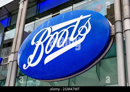 London, England - August 2021: Large sign above the entrance to a branch of Boots the Chemist Stock Photo