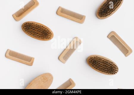 Wooden hair and beard combs flat lay on textured white background Stock Photo