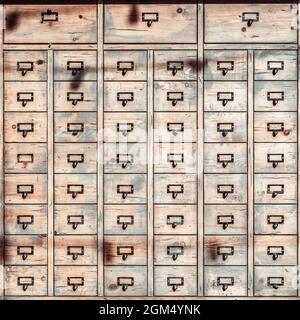 Old wooden cabinet with lots of drawers, vintage square background Stock Photo