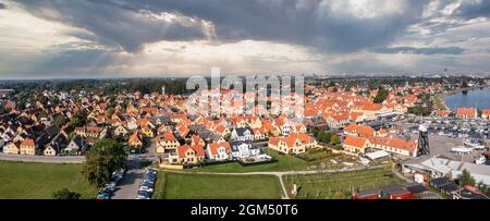 Beautiful, small, yellow rustic houses. Traditional Scandinavian style. Stock Photo