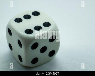 gambling white dice with number six on one side Stock Photo