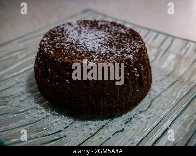 small chocolate cake topped with powdered sugar Stock Photo