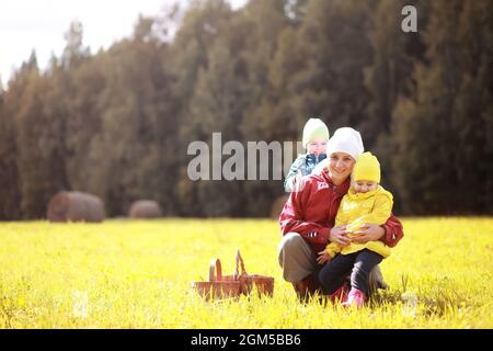 Children in village walk through the autumn forest and gather mushrooms. Children in nature are walking in nature. Rural walk in autumn. Stock Photo