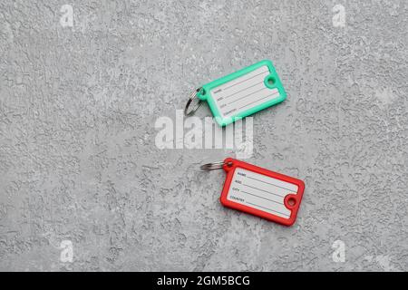 Plastic key tags on grunge background Stock Photo