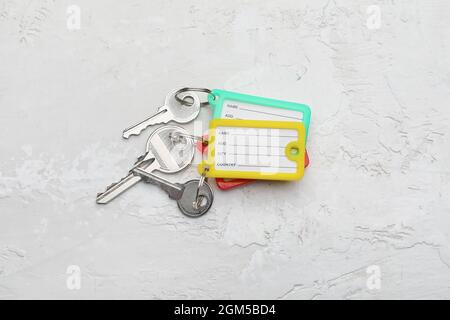 Keys with plastic tags on light background Stock Photo