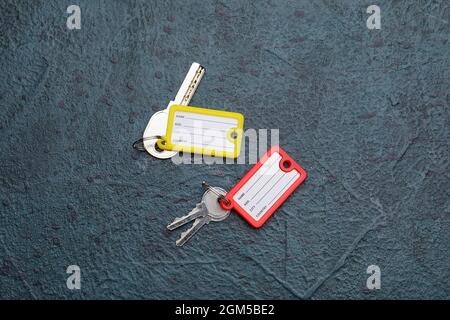 Keys with plastic tags on dark background Stock Photo