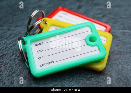 Plastic key tags on dark background Stock Photo