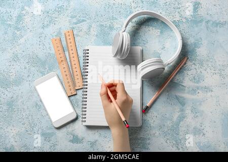 Woman with notebook and gadgets on grunge background Stock Photo