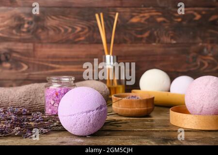 Set of bath supplies with bath bombs and lavender flowers on wooden background Stock Photo