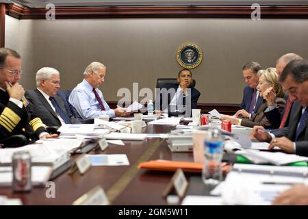 President Barack Obama listens during a meeting about the current situation in Pakistan Oct. 7, 2009 in the Situation Room of the White House. Left to right, Adm. Michael Mullen, chairman of the Joint Chiefs of Staff; Defense Secretary Robert Gates; Vice President Joe Biden; the President; National Security Advisor Gen. James Jones; Secretary of State Hillary Clinton; Director of National Intelligence Adm. Dennis C. Blair (partially obscured); and CIA Director Leon Panetta.(Official White House photo by Pete Souza) Stock Photo