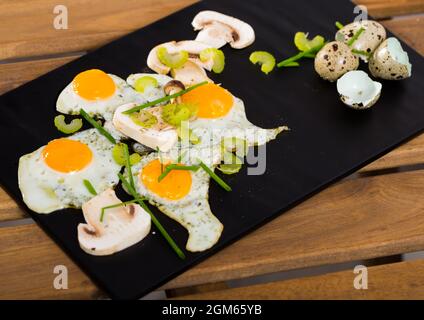 Broken quail eggs with champignons Stock Photo
