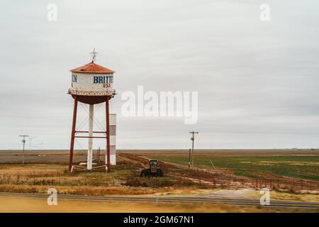 Old Britten Water tower leaning along the roadside in Texas landscape Stock Photo