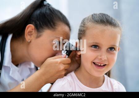 Otolaryngology Infection. Child Doctor Checking Ear Using Otoscope Stock Photo