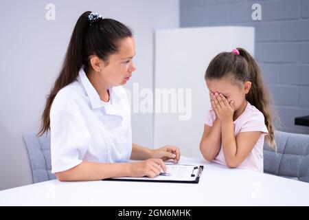 Sick Child Therapy. Therapist Comforting Kid At Hospital Stock Photo