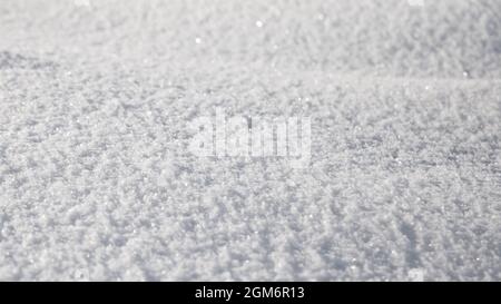 Smooth surface of clean fresh snow. Snowy ground. Winter background with snow patterns. Closeup top view. Wide panoramic texture for background and de Stock Photo