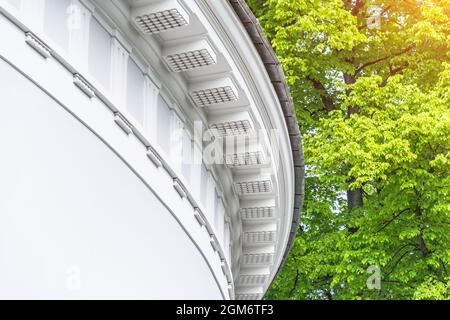 Part of a round building with stucco under the roof in the park Stock Photo