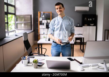 Smiling Entrepreneur Business Person Owner In Office Stock Photo