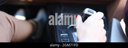 Woman hand holding automatic transmission lever closeup Stock Photo