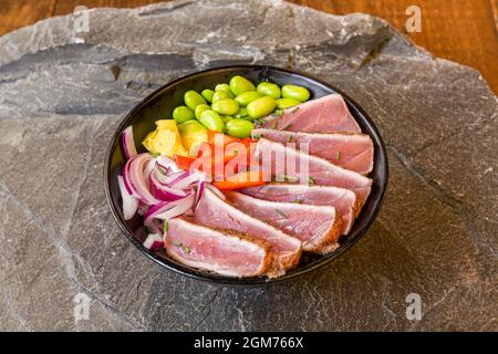 Marked on the Iron Bluefin Tuna Tataki Bowl with Edamame, Chopped Red Pepper and Red Onion Stock Photo