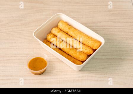 home delivery tray with huge fried cheese stuffed tequeños and dipping sauce Stock Photo