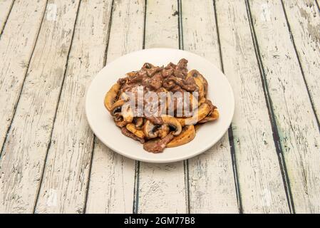 Typical Chinese restaurant dish made with beef and mushrooms and oyster sauce Stock Photo