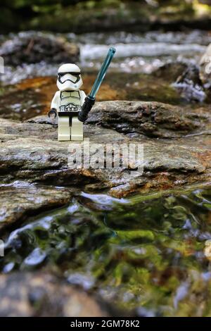 GREENVILLE, UNITED STATES - Aug 29, 2021: A vertical shot of a stormtrooper lego figure on a wet stone surface in Greenville, United States Stock Photo