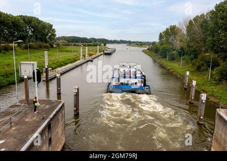 A boat sails through the sluice at the river 'the Maas' in the city of Roermond, province of Limbug, in the Netherlands Stock Photo