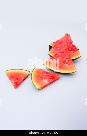 Triangular seedless watermelon chunks on light colored table Stock Photo