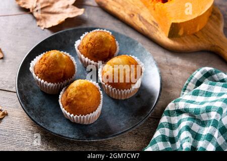 Pumpkin muffins on wooden table Stock Photo