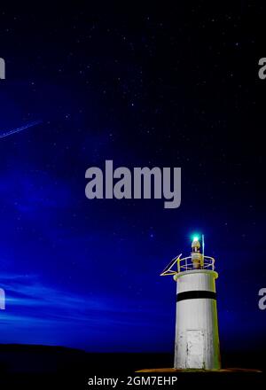 night starry sky image of maritime lighthouse on the black sea coast in Agva, Turkey Stock Photo