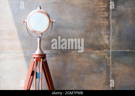 set of retro spotlights on tripods in grunge wall background with copy space and text Stock Photo