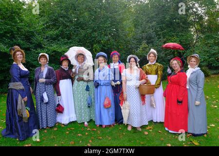 Jane Austen enthusiasts in Regency Period costume make a procession through the city. The annual festival draws Austen enthusiasts from all over the w Stock Photo