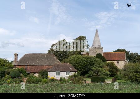 ALFRISTON, EAST SUSSEX, UK - SEPTEMBER 13 : View of St Andrews Church and Clergy House in Alfriston, East Sussex on September 13, 2021. Two unidentifi Stock Photo