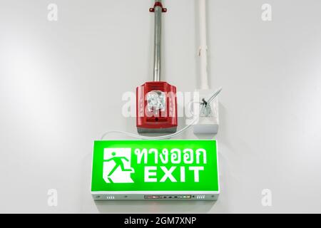 Fire protection alarm and emergency exit sign in modern offices inside an industrial plant Stock Photo