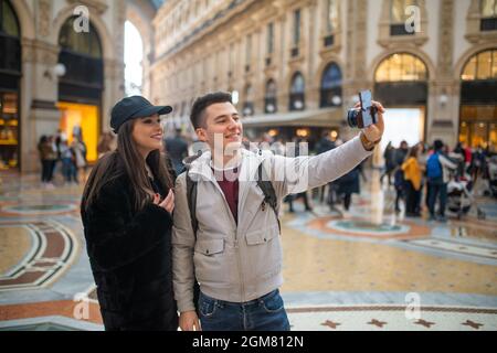 Couple of turists taking a selfie in the city of Milan, Italy Stock Photo