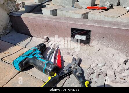 installation of the lamp in a concrete curb. Selective focus Stock Photo
