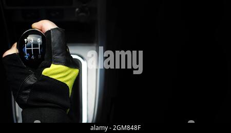 Gear lever. Manual Transmission. Hand on the gear shift in a car. Stock Photo