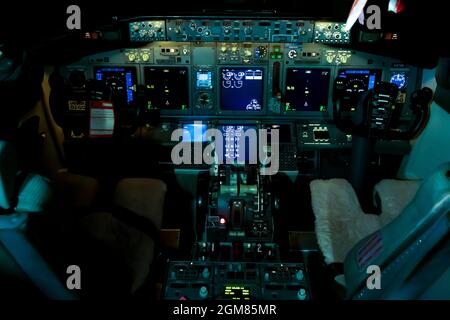 Ukraine, Kiev - December 29, 2020: Airplane cockpit aircraft - UR-SQE. Boeing 737-75C. Plane instrument panel. Pilot seat. Night Stock Photo