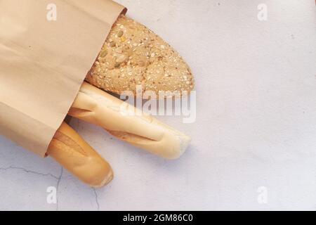 whole grain baked bread in a shopping bag on table  Stock Photo