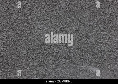 Concrete putty texture. Plaster on the wall. Rough granular surface. The surface is gray. Stock Photo