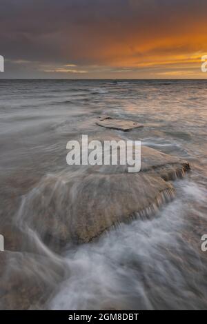 Summertime Sunset as the tide floods in, Kimmeridge Bay, Dorset. Jurassic Coast Stock Photo