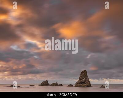 Sunrise on a cloudy morning over Mupe Bay on the Dorset Jurassic Coastline, UK Stock Photo