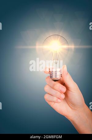 Good ideas with innovation and creativity concept. Young women hand holding lightning bulb Stock Photo