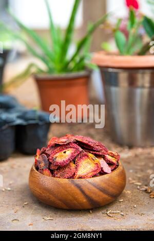 Dried strawberry fruits sliced chips on the table. Stock Photo