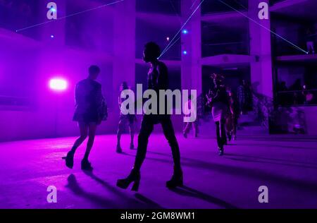 Models on the catwalk during the Edward Crutchley show at London Fashion Week September 2021 held in the Collins Music Hall in London. Picture date: Friday September 17, 2021. Stock Photo