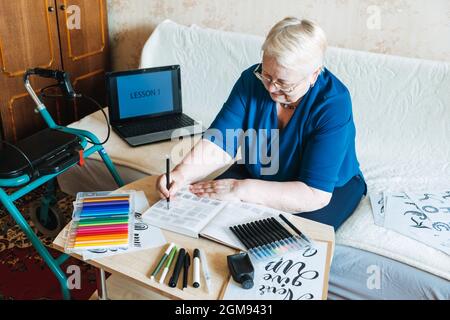 Hobby Ideas for Older People. Retirement Hobbies, Pastimes for Seniors. Activities for Seniors with Limited Mobility. Mature, elderly woman practices Stock Photo