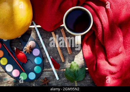 Autumn aesthetic still life: fruits, vegetables and bright paints with a cinnamon sticks, viburnum, flower petals and cup of tea. Thanksgiving Day con Stock Photo