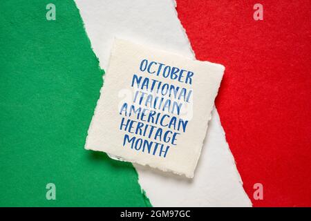 October - National Italian American Heritage Month, handwriting on handmade paper against abstract in colors of national flag of Italy (green, white a Stock Photo